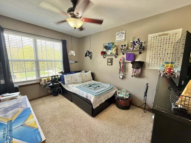 carpeted bedroom with baseboards, a textured ceiling, and ceiling fan