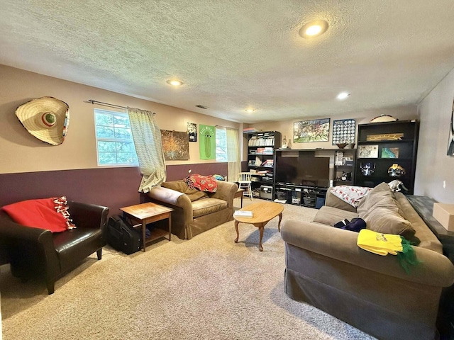 carpeted living room featuring recessed lighting and a textured ceiling