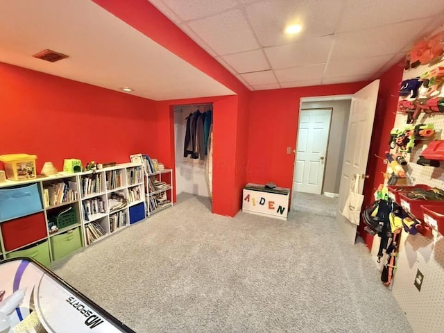 game room with carpet floors, a drop ceiling, and visible vents