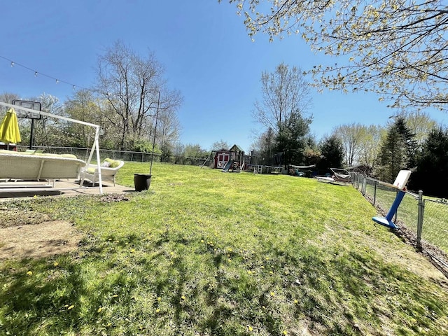 view of yard featuring a fenced backyard and a playground