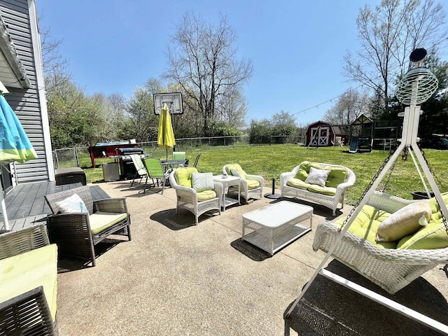 view of patio / terrace with an outdoor living space, an outbuilding, a shed, a fenced backyard, and outdoor dining space