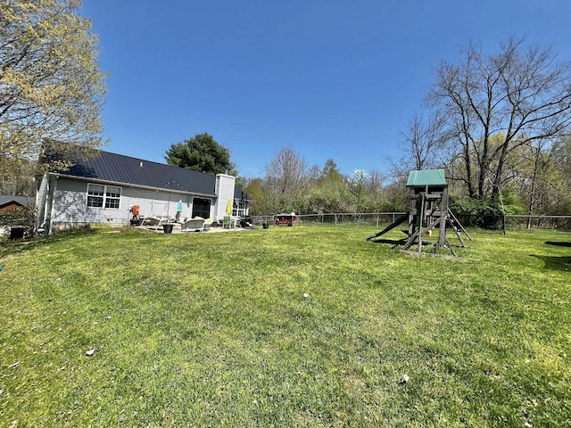 view of yard with a playground and fence