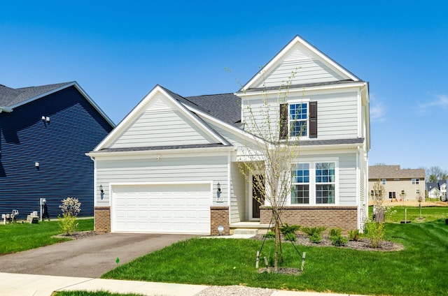 view of front facade with concrete driveway, brick siding, an attached garage, and a front lawn