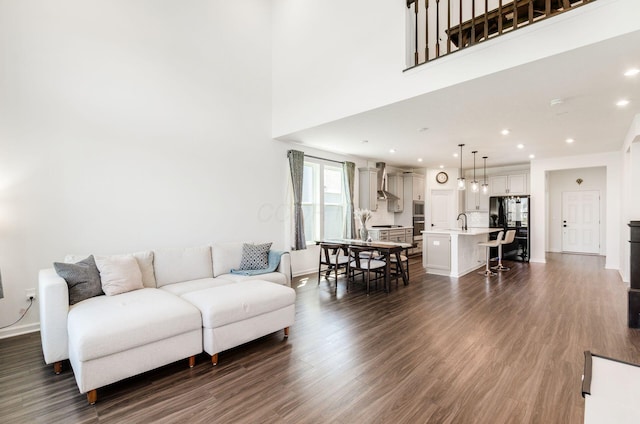 living room featuring recessed lighting, baseboards, and dark wood finished floors