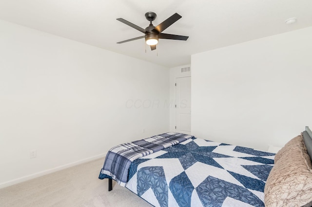 carpeted bedroom with baseboards, a ceiling fan, and visible vents