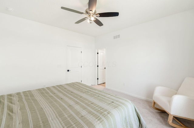 bedroom featuring light colored carpet, a ceiling fan, visible vents, and baseboards