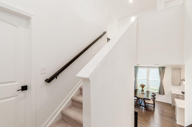 stairway featuring wood finished floors