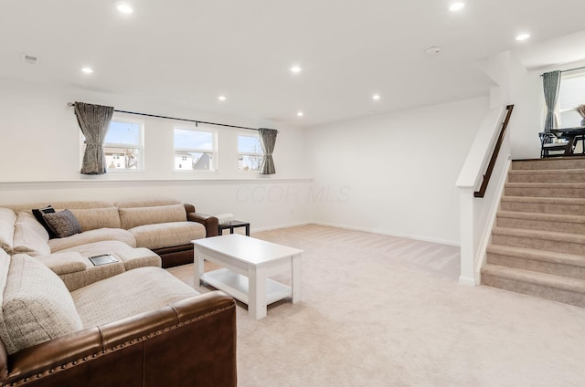 living room featuring stairway, recessed lighting, and light colored carpet