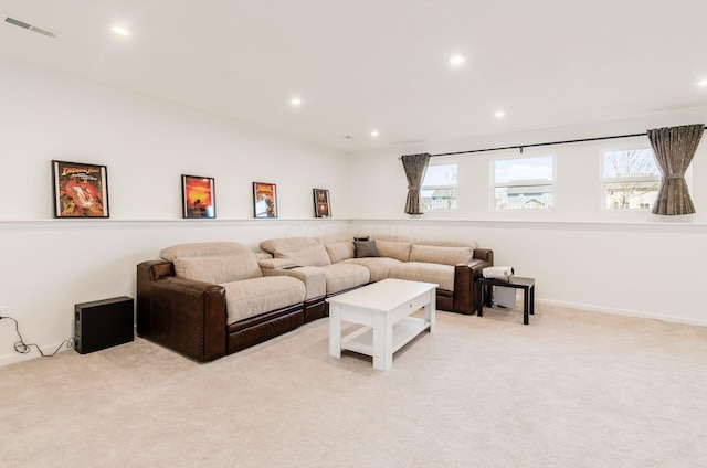 living area with visible vents, recessed lighting, and light colored carpet