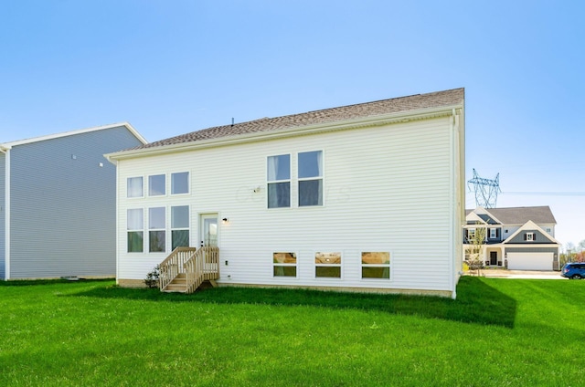 rear view of property featuring a yard