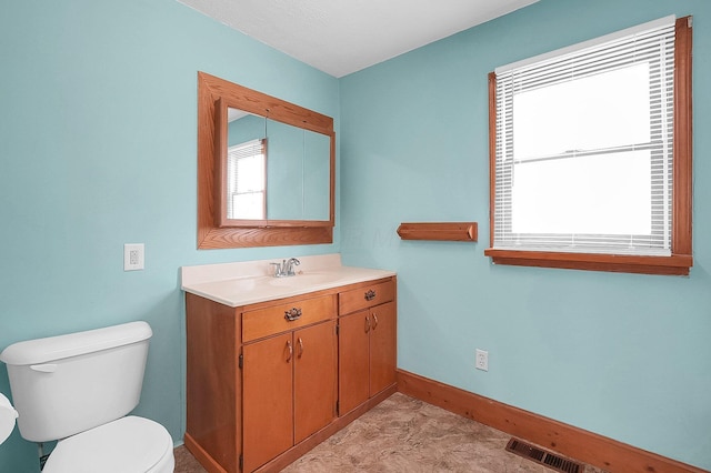 512 Henry St, Marion, OH 43302 - half bath with vanity, baseboards, toilet, and visible vents