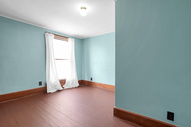 512 Henry St, Marion, OH 43302 - spare room featuring baseboards and wood-type flooring