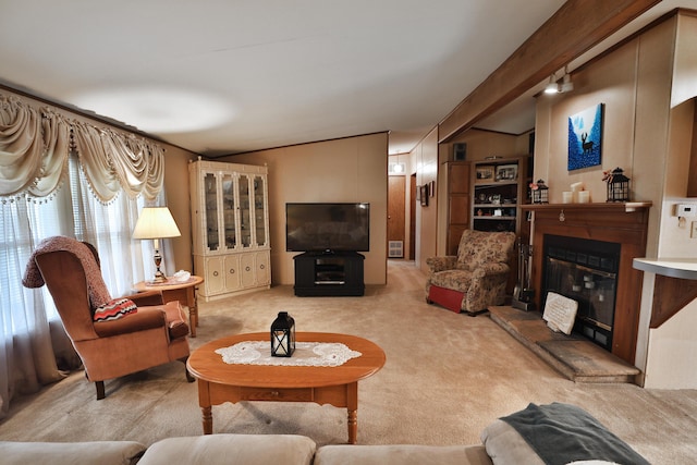 carpeted living area with visible vents and a glass covered fireplace