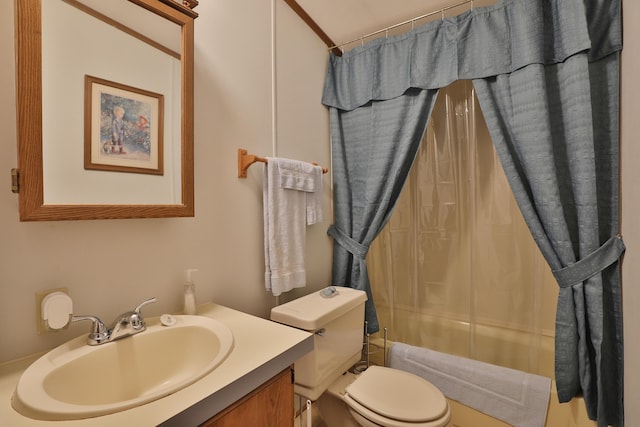 bathroom with vanity, shower / bath combo with shower curtain, and toilet