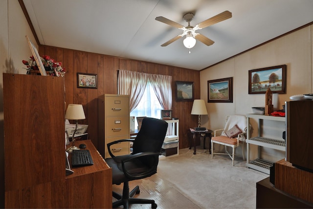 carpeted office space featuring wooden walls, a ceiling fan, and lofted ceiling