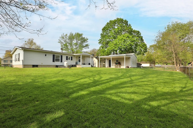 back of property featuring a yard, fence, and a patio area