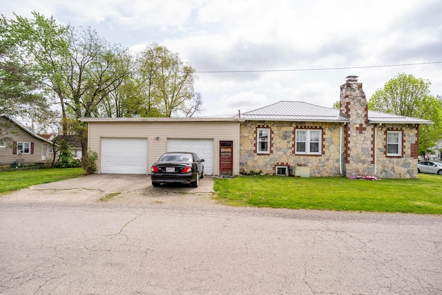 single story home featuring a garage, a front lawn, concrete driveway, stone siding, and metal roof