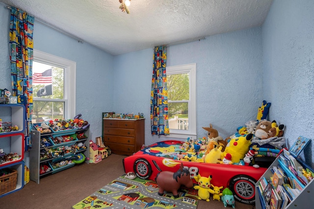 bedroom featuring carpet flooring, a textured wall, and a textured ceiling