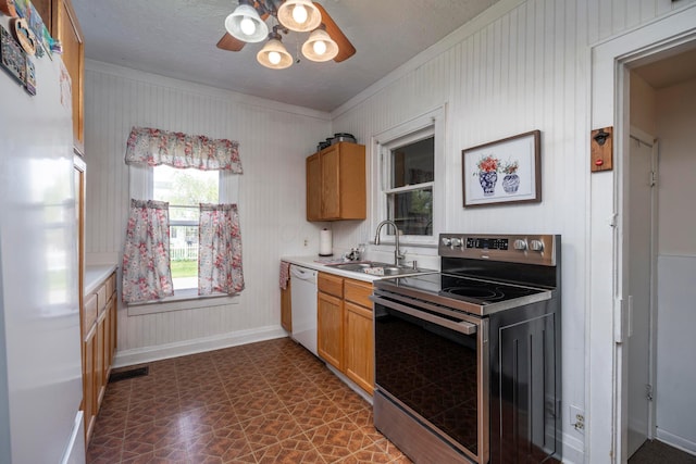 kitchen with crown molding, white dishwasher, refrigerator, a sink, and electric stove