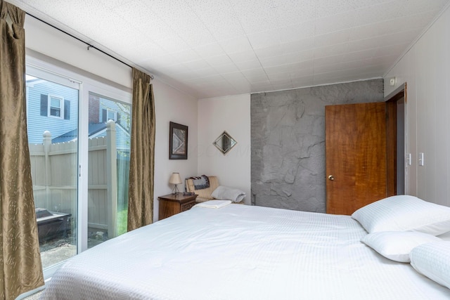 bedroom with ornamental molding and an accent wall