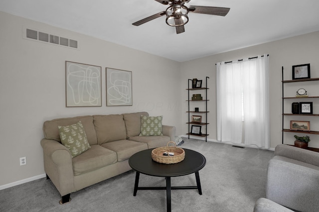 carpeted living area featuring visible vents, a ceiling fan, and baseboards