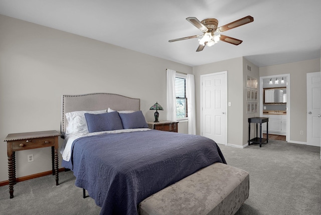bedroom featuring carpet floors, baseboards, and connected bathroom