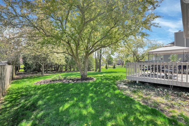 view of yard featuring a gazebo, fence, and a deck