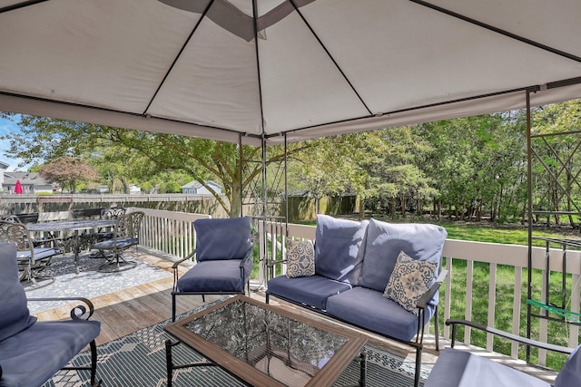 wooden deck featuring fence, outdoor dining space, and an outdoor hangout area