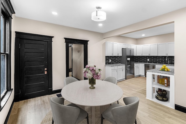 dining room featuring recessed lighting and light wood-style flooring