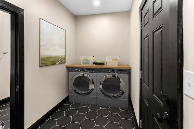 washroom featuring laundry area, recessed lighting, baseboards, dark tile patterned flooring, and washer and clothes dryer