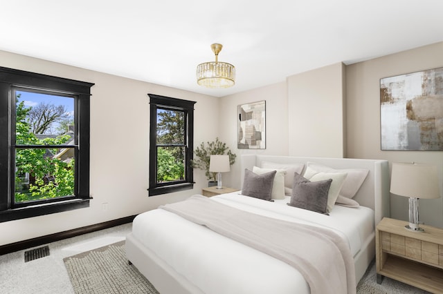 bedroom featuring baseboards, multiple windows, carpet, and visible vents