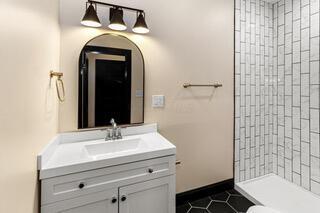 full bathroom with vanity, tile patterned flooring, and tiled shower