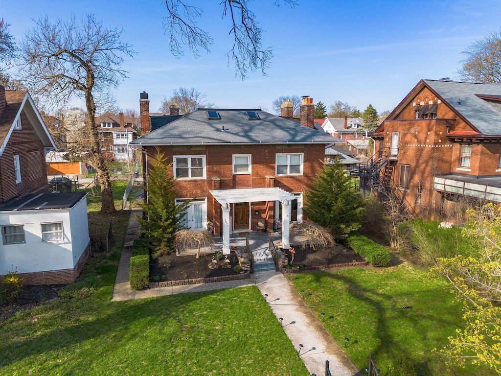 rear view of property with a residential view, a pergola, and a chimney
