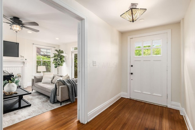 1800 Bryden Rd, Columbus, OH 43205 - foyer entrance with dark wood-style floors, baseboards, a ceiling fan, a fireplace, and recessed lighting