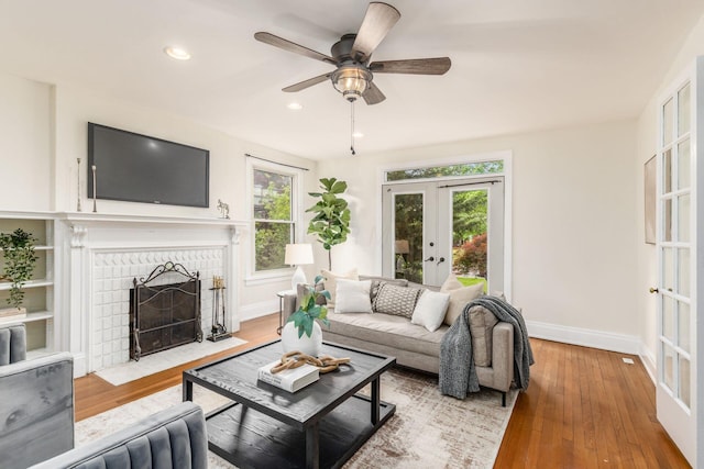 1800 Bryden Rd, Columbus, OH 43205 - living area featuring french doors, a fireplace with flush hearth, ceiling fan, recessed lighting, and hardwood / wood-style floors