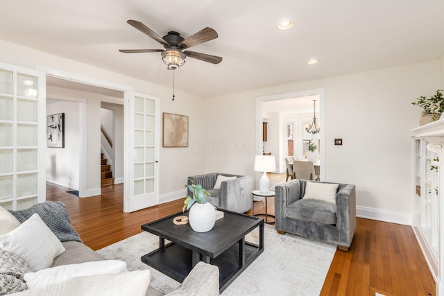 1800 Bryden Rd, Columbus, OH 43205 - living area featuring stairway, wood finished floors, ceiling fan, a chandelier, and baseboards