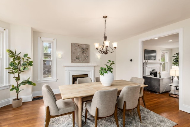 1800 Bryden Rd, Columbus, OH 43205 - dining space with a fireplace, wood finished floors, and healthy amount of natural light