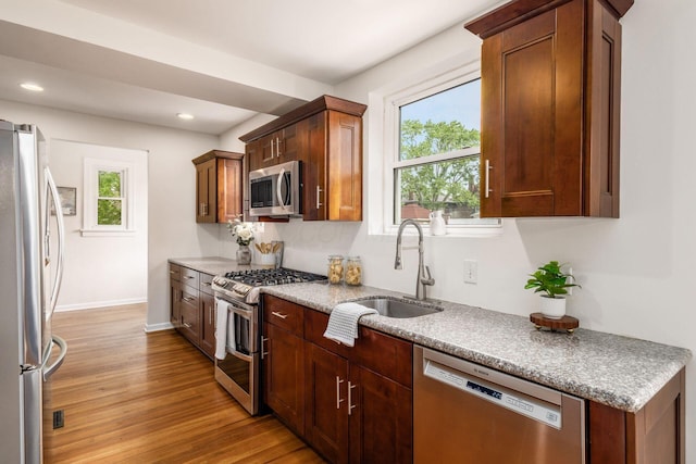1800 Bryden Rd, Columbus, OH 43205 - kitchen featuring stainless steel appliances, a sink, light wood-type flooring, plenty of natural light, and recessed lighting