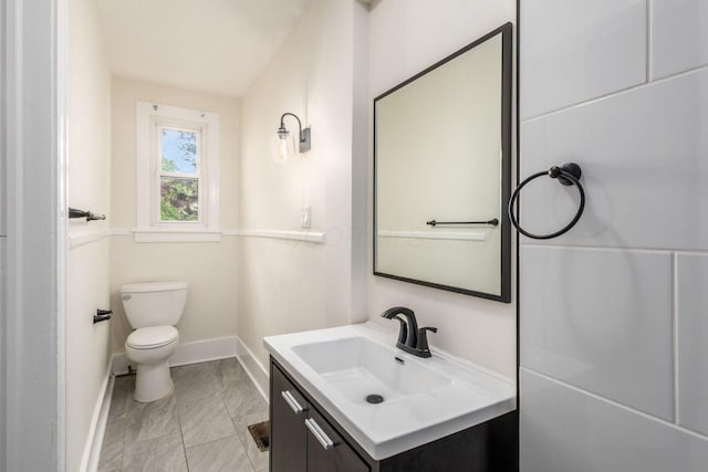 1800 Bryden Rd, Columbus, OH 43205 - bathroom featuring baseboards, toilet, vanity, and marble look tile flooring
