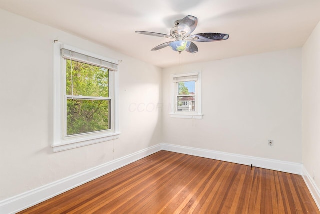 1800 Bryden Rd, Columbus, OH 43205 - spare room with baseboards, wood finished floors, and ceiling fan