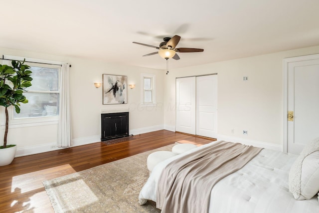 1800 Bryden Rd, Columbus, OH 43205 - bedroom with wood finished floors, a fireplace with flush hearth, baseboards, and a closet