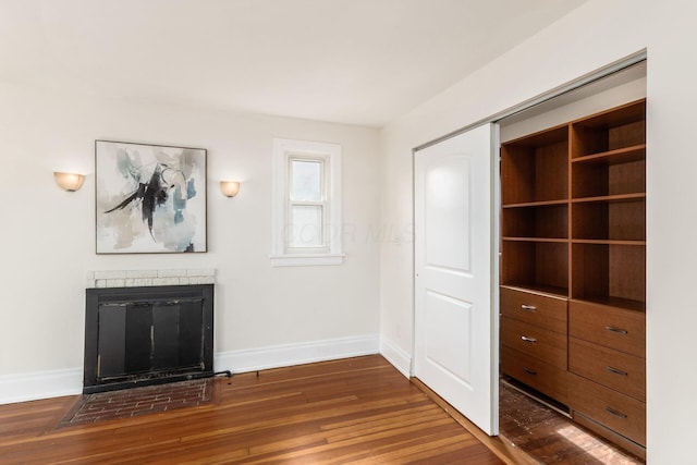 1800 Bryden Rd, Columbus, OH 43205 - unfurnished living room with dark wood-type flooring, baseboards, and a fireplace