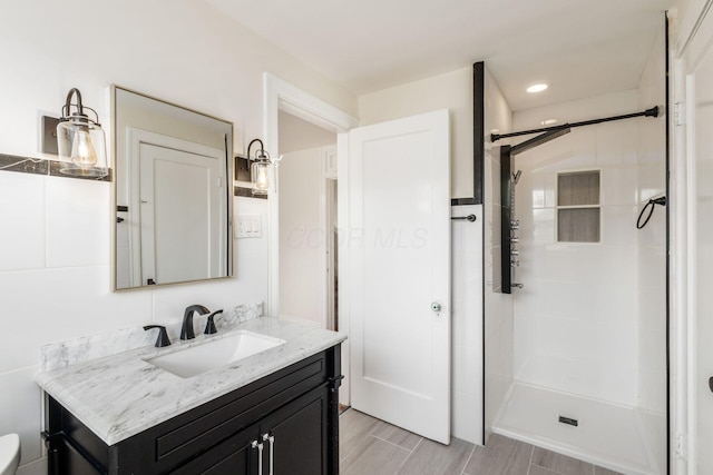 1800 Bryden Rd, Columbus, OH 43205 - bathroom with a stall shower, vanity, and wood finished floors