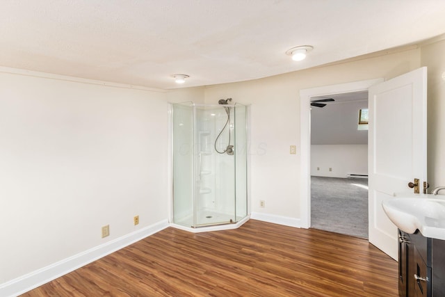 1800 Bryden Rd, Columbus, OH 43205 - empty room with wood finished floors, baseboards, a baseboard heating unit, and a sink