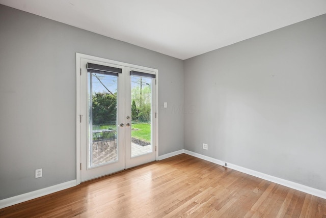 doorway to outside with light wood-style floors, baseboards, and french doors