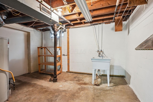 unfinished basement with concrete block wall and water heater