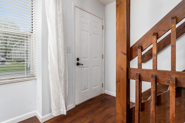 entryway featuring baseboards and dark wood finished floors