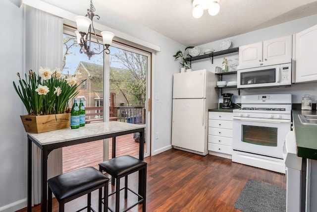 kitchen with white cabinets, open shelves, white appliances, a chandelier, and dark wood finished floors