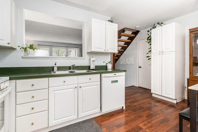 kitchen with white dishwasher, dark wood-style floors, a sink, and white cabinetry