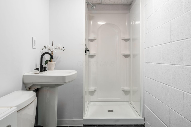 full bath featuring toilet and a stall shower